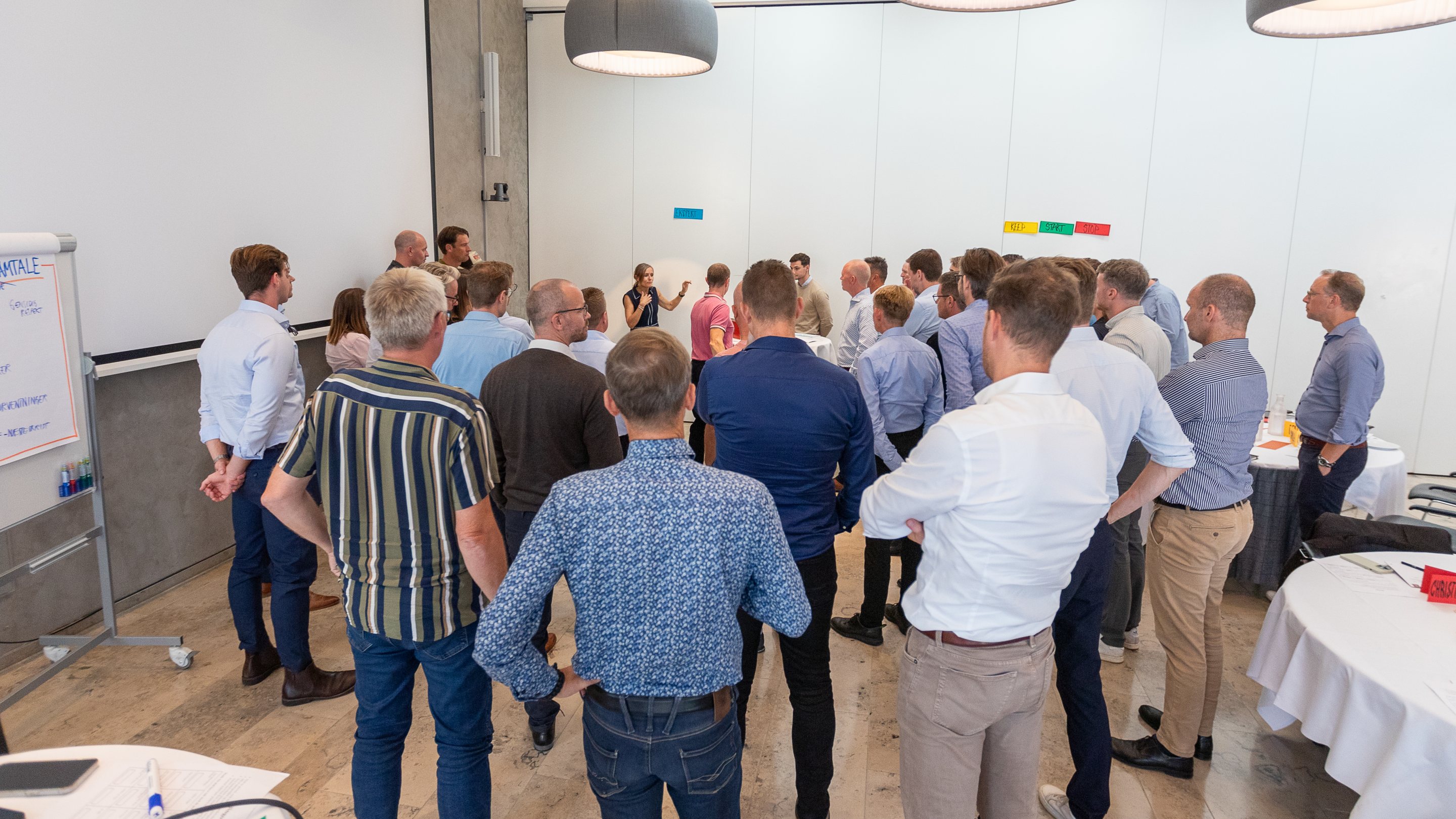 ZILLION consultants standing together in a workshop huddle